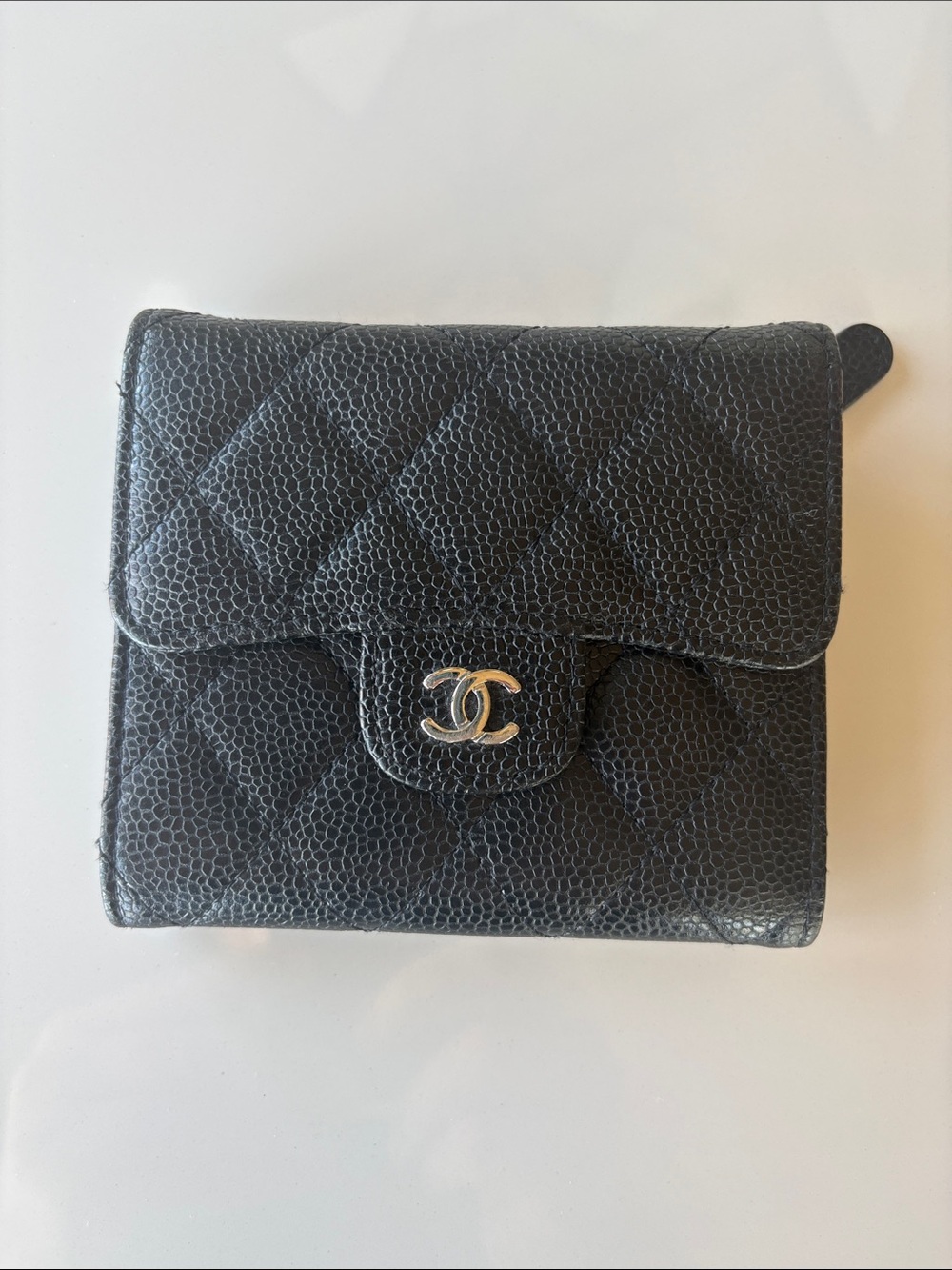 CHANEL Black Quilted Caviar Leather Compact Wallet with CC Snap Enclosure.